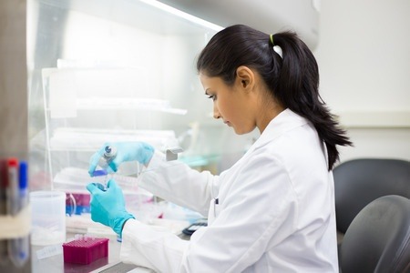 31375091 - closeup portrait, scientist holding 50 ml conical tube with blue liquid solution, performing laboratory experiments, isolated lab . forensics, genetics, microbiology, biochemistry